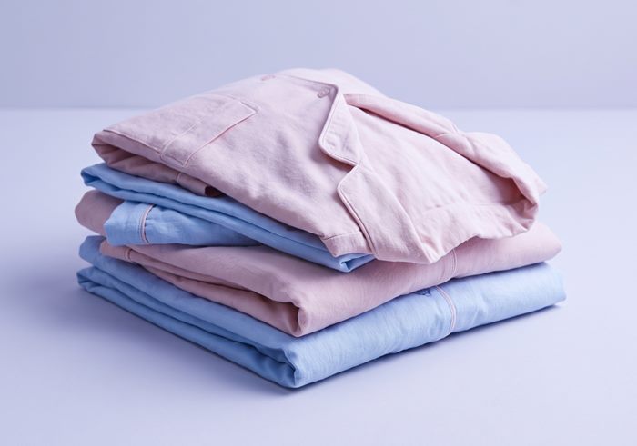 Folded pyjama set in blush and pale blue woven cotton
